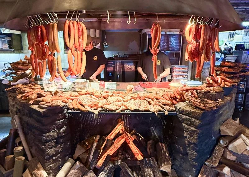 Open-fire cooking with assorted meats and sausages at Dalmaji; photograph date unknown.
