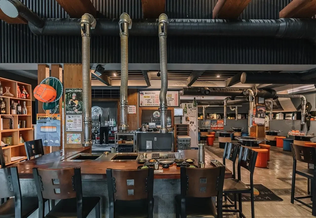 Haenyeo Gogi dining room with tabletop grills and haenyeo-themed decor; capture date unknown.