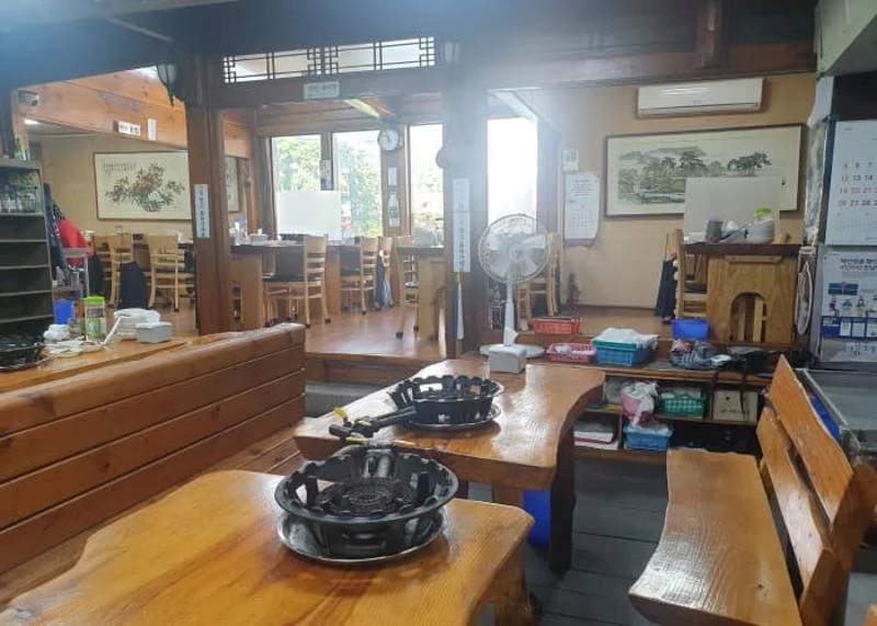 Jonggajib's wood-lined dining room and tabletop grills; photograph date unknown.